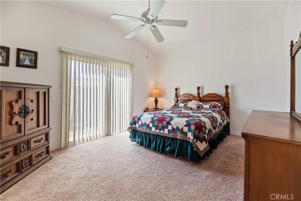 2664 Hazy Way Banning, CA 92220 - Photo 25 of 56 a bedroom with a bed and a chandelier