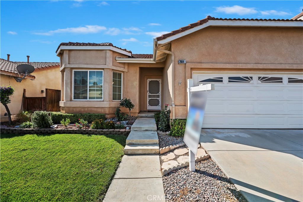 2664 Hazy Way Banning, CA 92220 - Photo 3 of 56 a front view of a house with a yard and potted plants