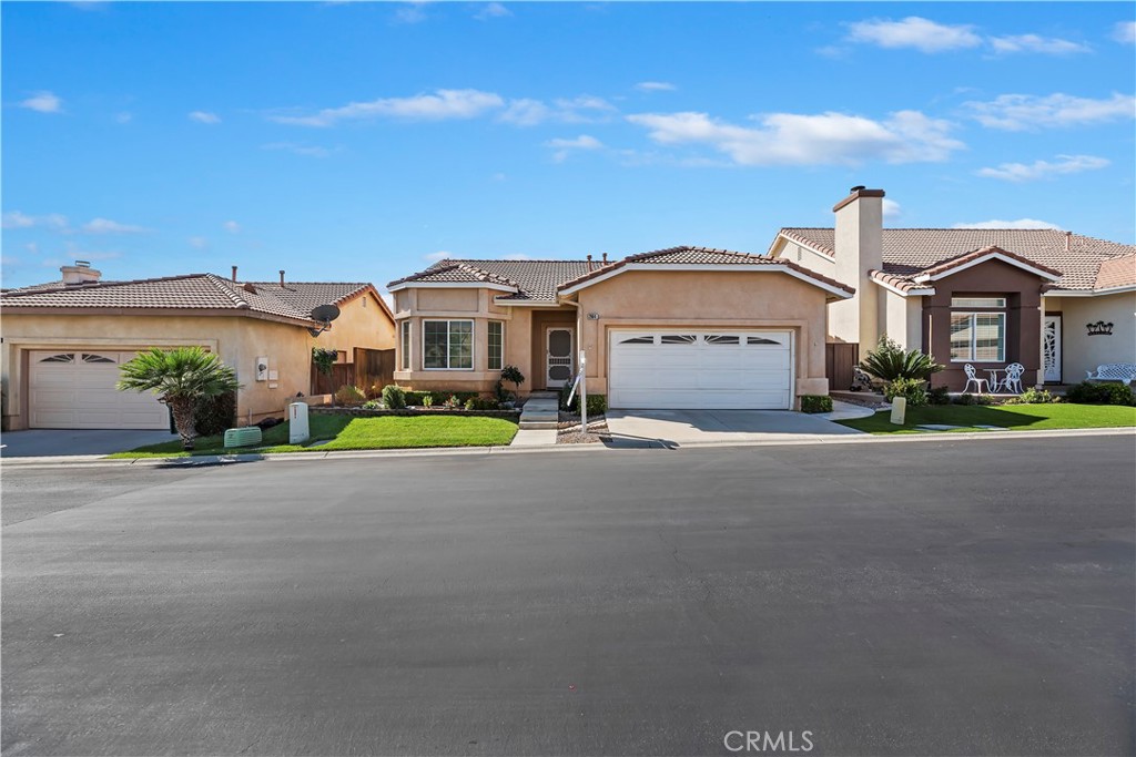 2664 Hazy Way Banning, CA 92220 - Photo 6 of 56 a front view of a house with a garden and plants
