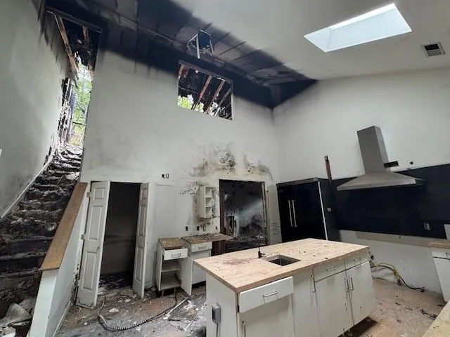 a view of kitchen island with sink stove and refrigerator