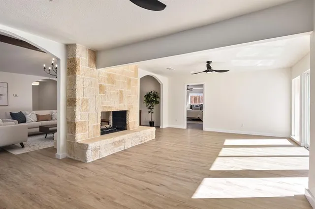 a view of an empty room and fire place