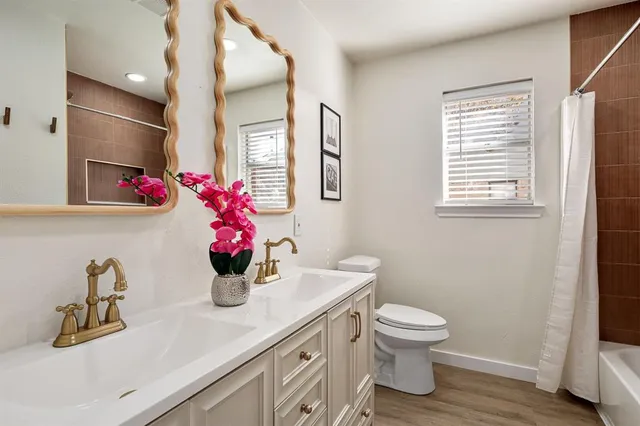 a bathroom with a toilet sink and mirror