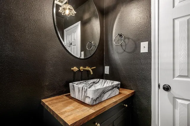a bathroom with a mirror and a sink