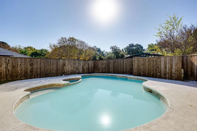 a view of a swimming pool with a yard