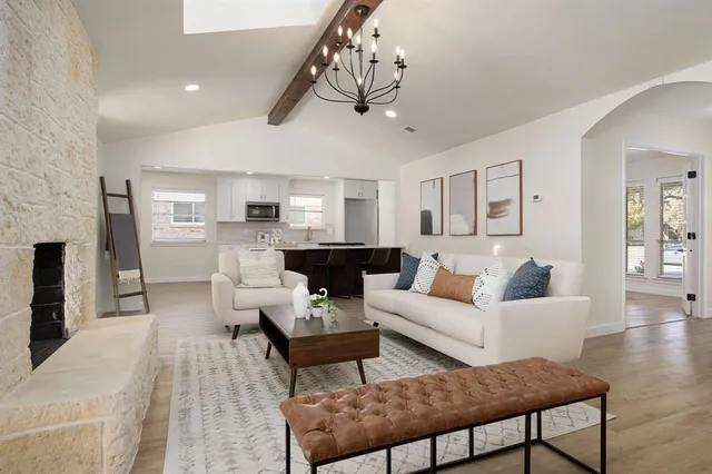 a living room with furniture and a chandelier