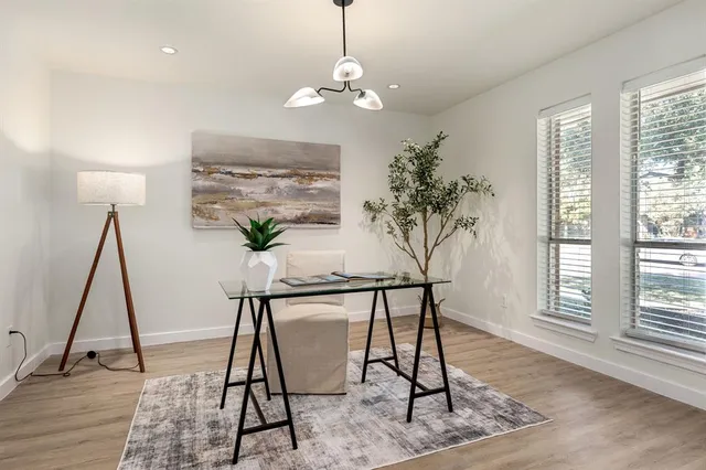 a view of a livingroom with furniture wooden floor and a chandelier