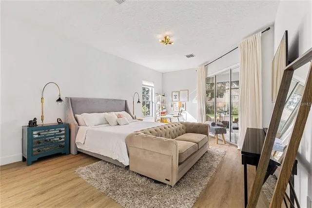 a view of a kitchen with refrigerator and wooden floor