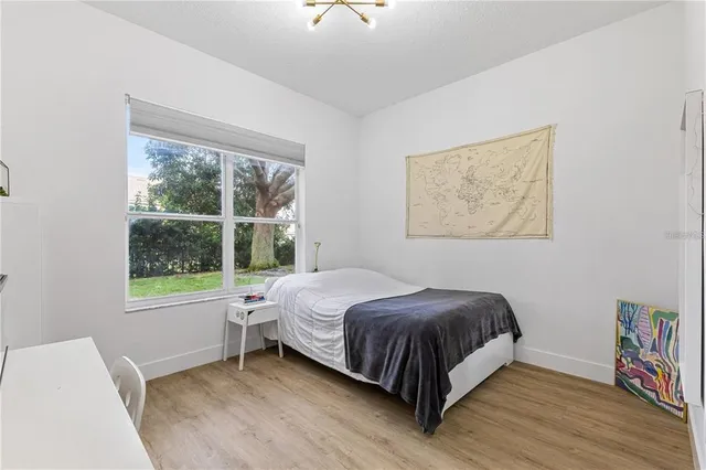 a front view of a house with a garden and trees