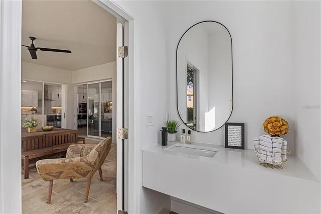 a view of kitchen with granite countertop stainless steel appliances a sink a counter and chairs