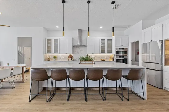 a kitchen with stainless steel appliances a refrigerator sink and cabinets
