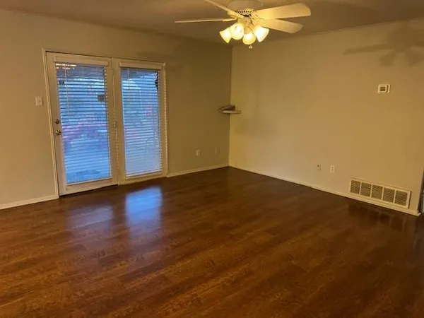 a view of a room with wooden floor and city view
