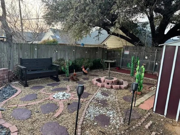 a view of a backyard with sitting area and a garden