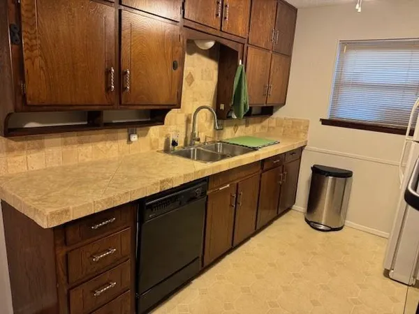 a kitchen with stainless steel appliances a refrigerator and a stove