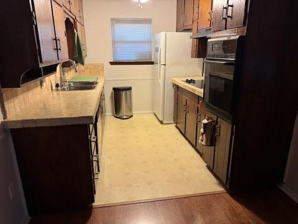 a kitchen with granite countertop cabinets and steel stainless steel appliances