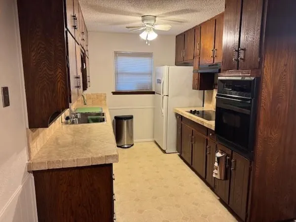 a view of a kitchen from the hallway