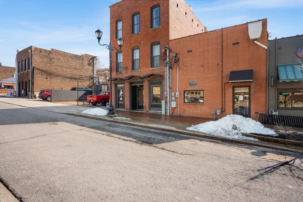 a view of a room with wooden floor and ceiling fan
