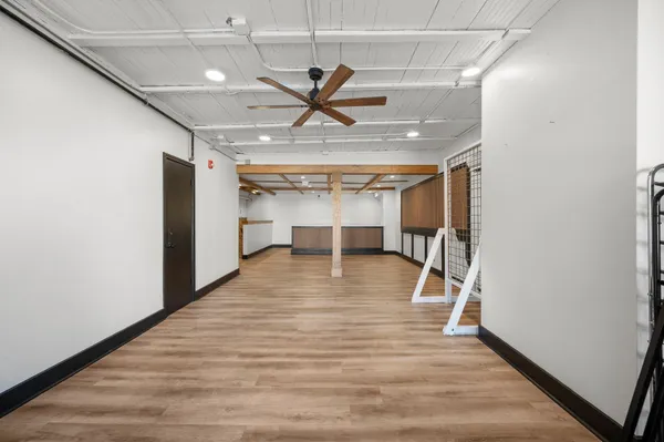 a view of an empty room with wooden floor