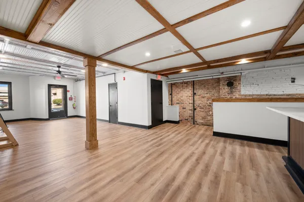 a view of a room with wooden floor