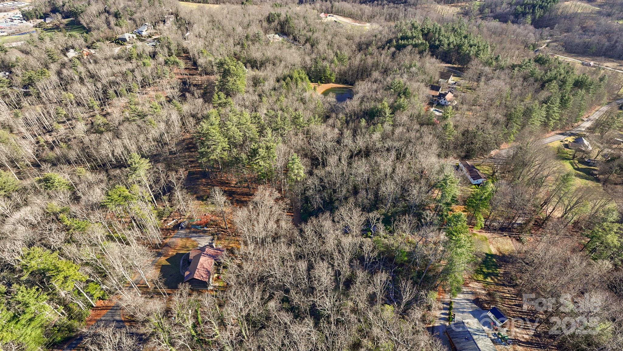 Tbd Longview Road Spruce Pine, NC 28777 - Photo 3 of 16 a view of a house with a lush green forest