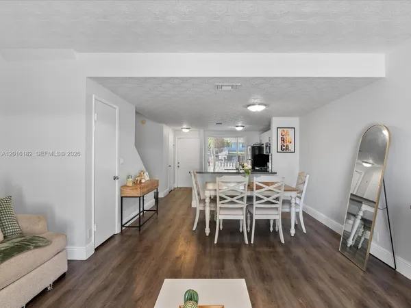 a dining room with furniture and wooden floor