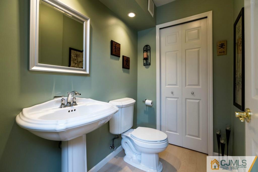 104 South Cliff Road Colonia, NJ 07067 - Photo 11 of 25 a bathroom with a sink and a mirror