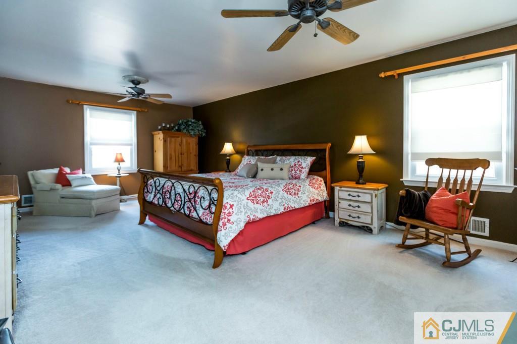 104 South Cliff Road Colonia, NJ 07067 - Photo 14 of 25 a bedroom with a bed and a chandelier