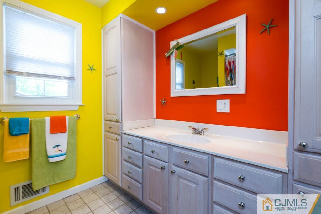 104 South Cliff Road Colonia, NJ 07067 - Photo 19 of 25 a bathroom with a sink and a mirror