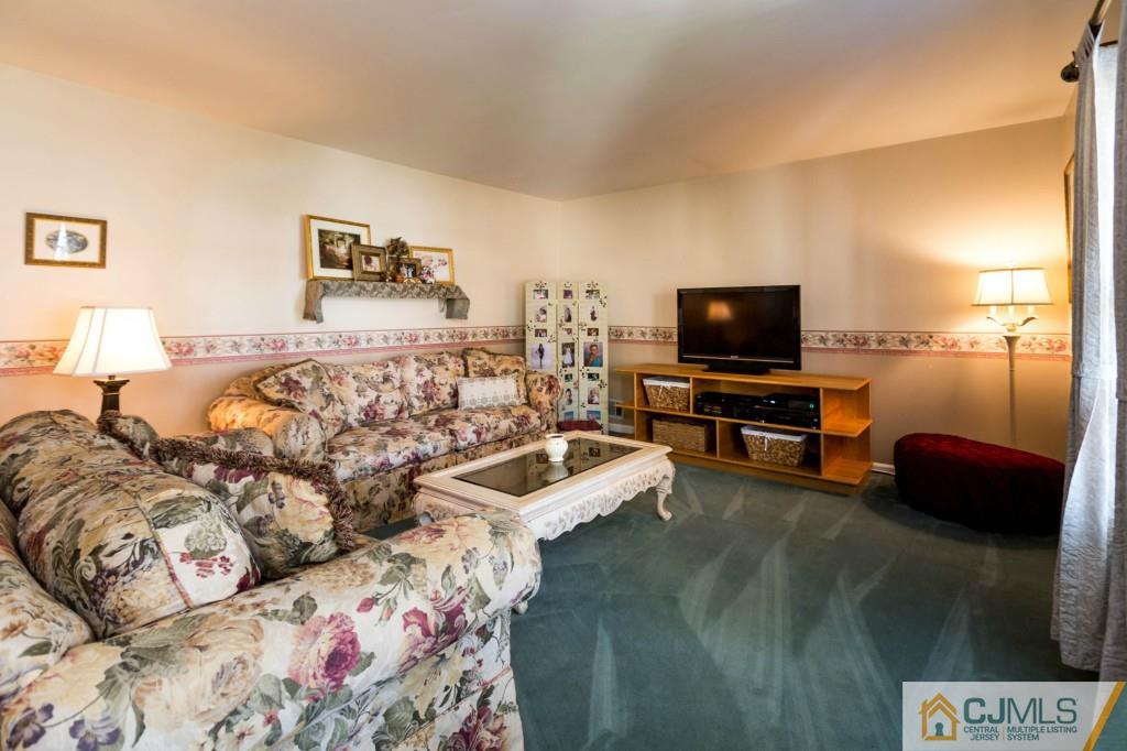 104 South Cliff Road Colonia, NJ 07067 - Photo 3 of 25 a living room with furniture and a flat screen tv