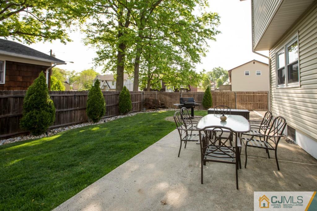104 South Cliff Road Colonia, NJ 07067 - Photo 23 of 25 a view of a back yard with a table and a chairs
