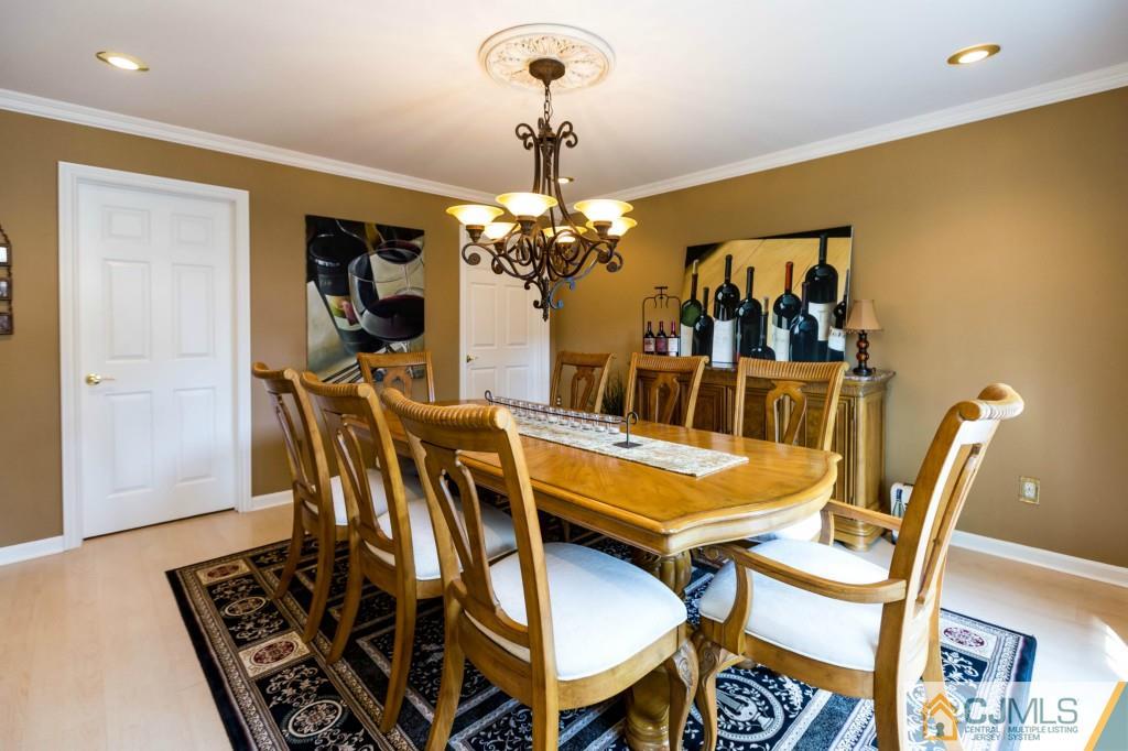 104 South Cliff Road Colonia, NJ 07067 - Photo 5 of 25 a view of a dining room with furniture and a chandelier