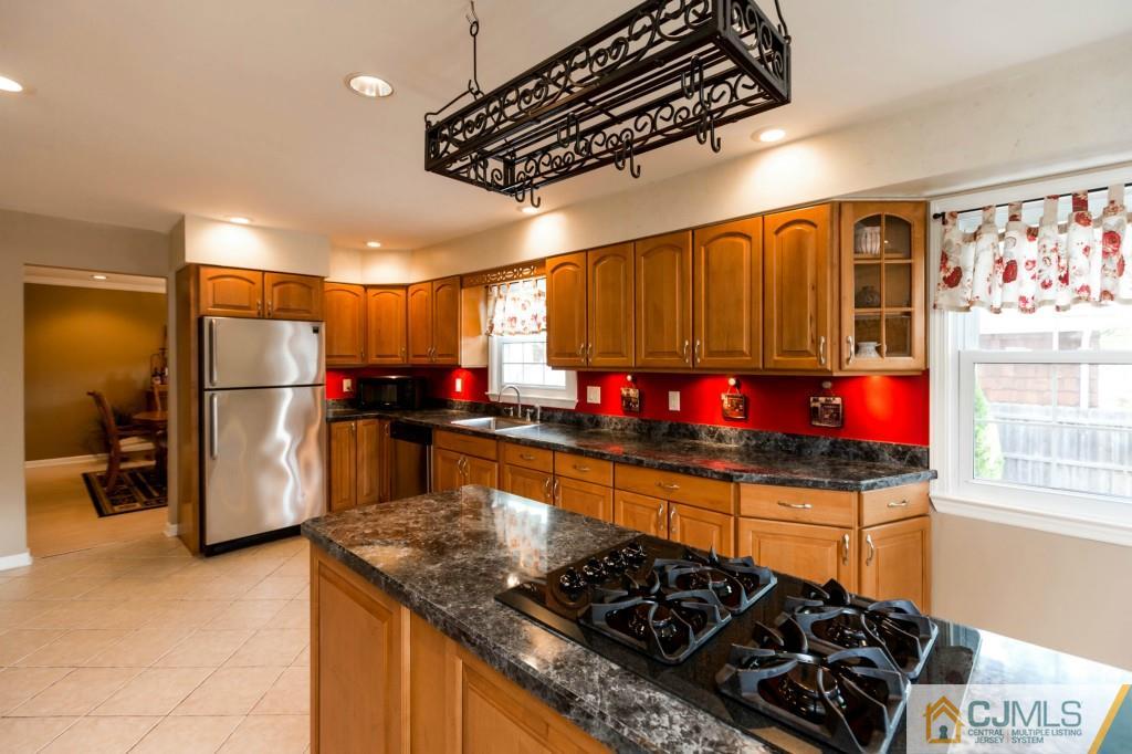 104 South Cliff Road Colonia, NJ 07067 - Photo 6 of 25 a kitchen with stainless steel appliances granite countertop a stove and a refrigerator
