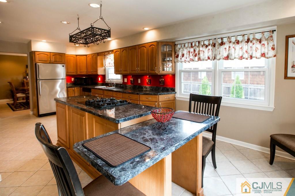 104 South Cliff Road Colonia, NJ 07067 - Photo 8 of 25 a kitchen with stainless steel appliances granite countertop a stove a sink and a refrigerator