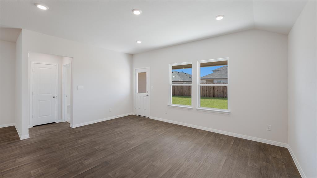 14021 Feinstein Street Manor, TX 78653 - Photo 12 of 25 Recessed lighting illuminates this room, complemented by views of the private yard.