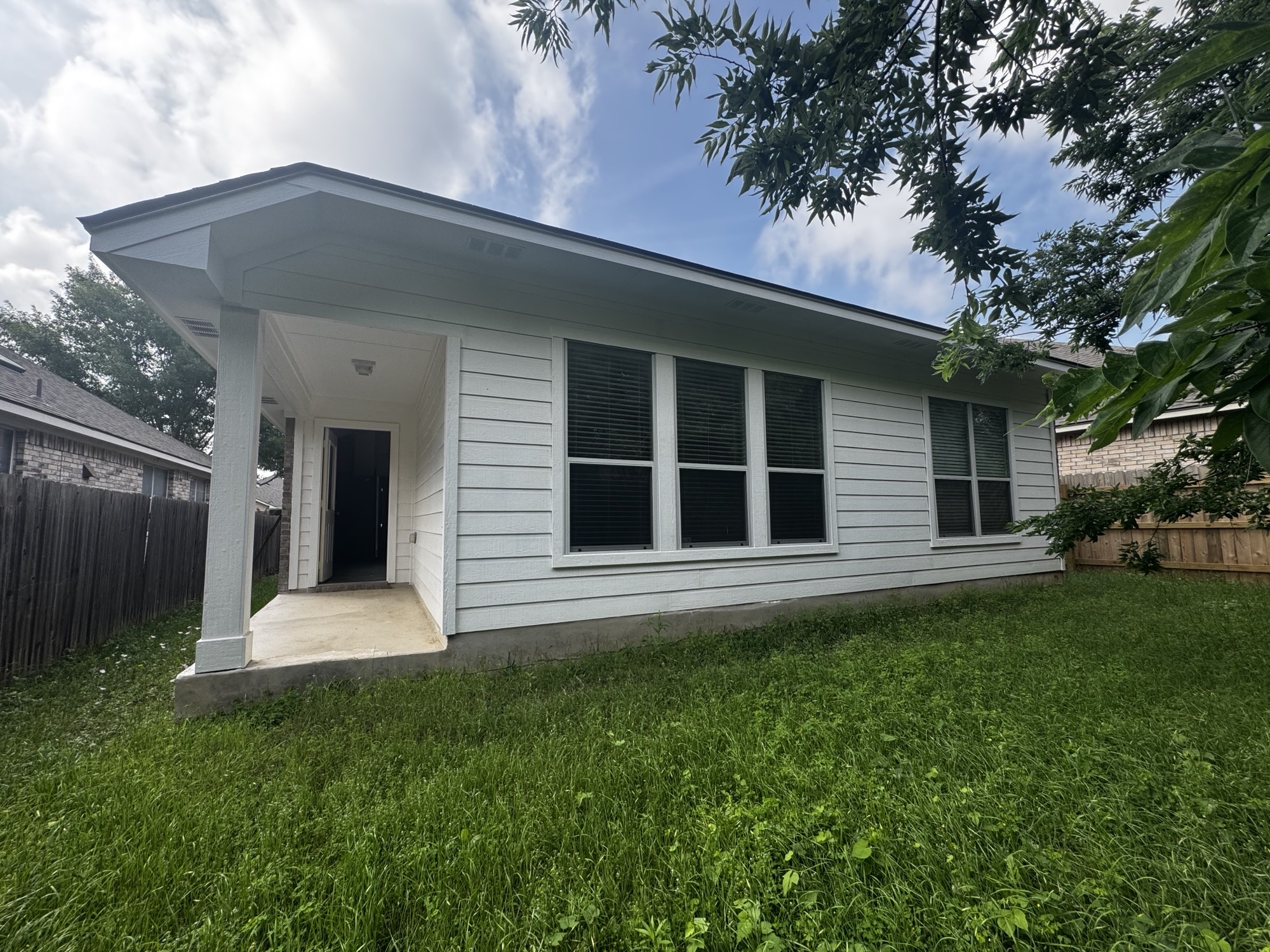 304 Valona Loop Round Rock, TX 78681 - Photo 14 of 15 Rear exterior featuring white horizontal siding and a covered patio with a concrete slab