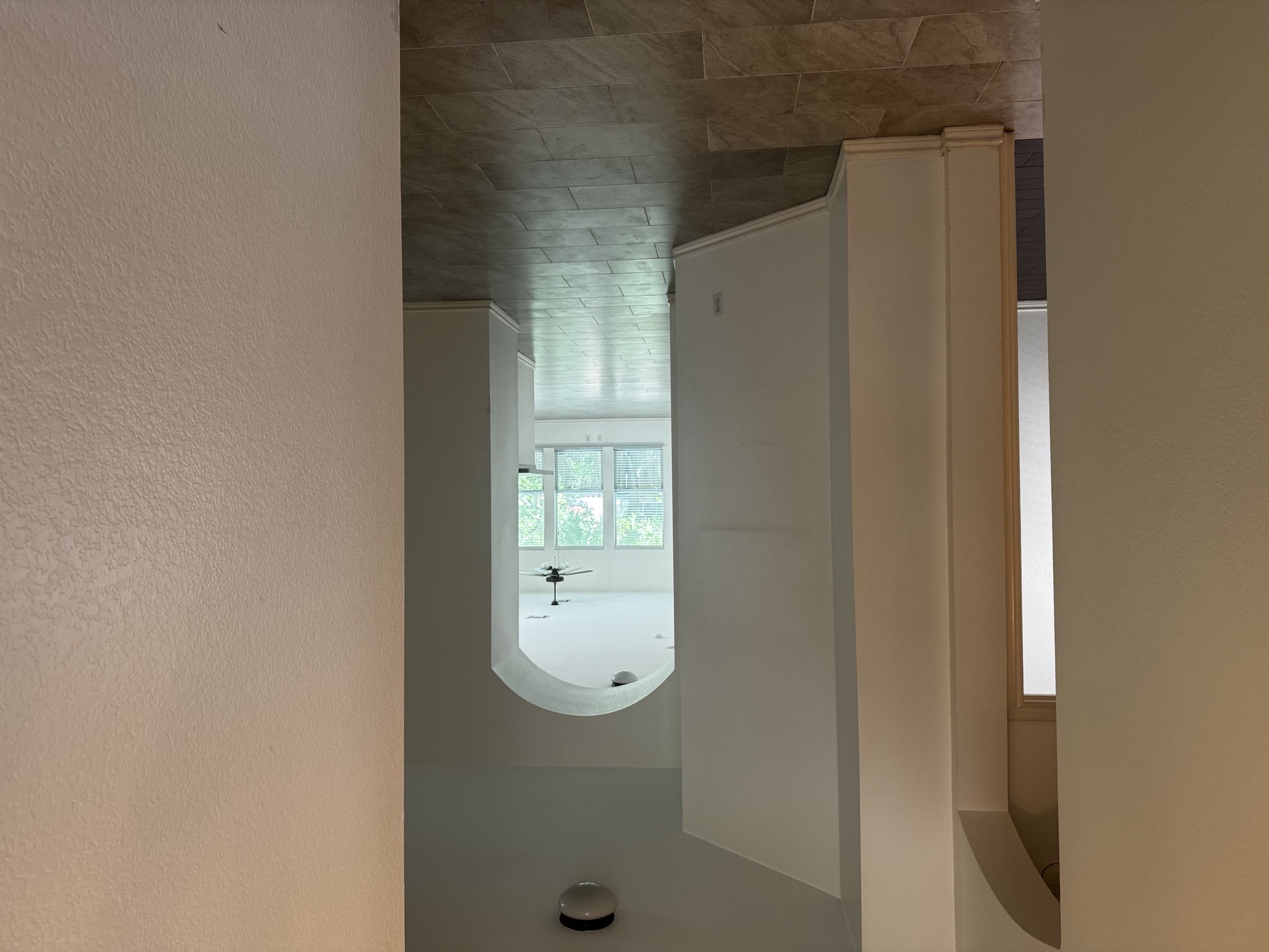 304 Valona Loop Round Rock, TX 78681 - Photo 2 of 15 Interior hallway featuring arched doorways, light-colored walls, and tile flooring