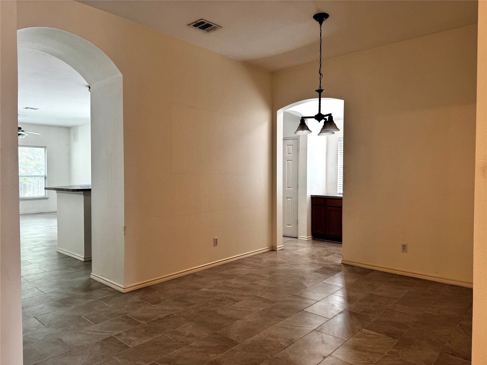 304 Valona Loop Round Rock, TX 78681 - Photo 3 of 15 Ceramic tile flooring throughout, featuring arched doorways and a three-light chandelier