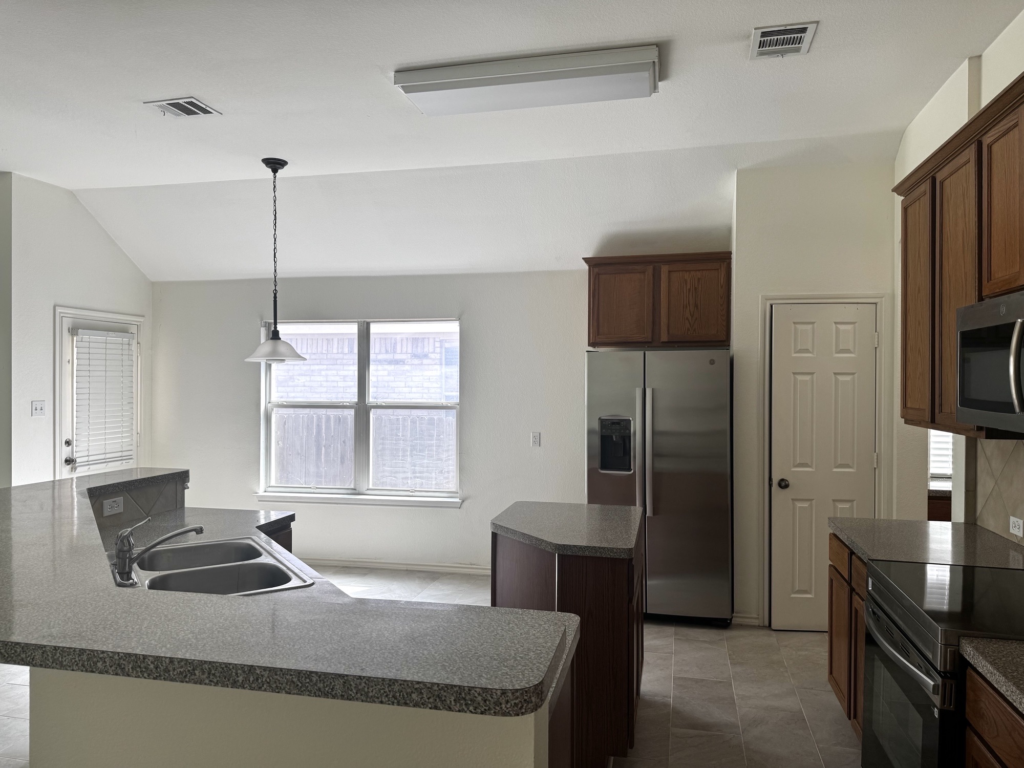 304 Valona Loop Round Rock, TX 78681 - Photo 7 of 15 Kitchen featuring title floor, stainless steel appliances. Brand new refrigerator and electric cooktop