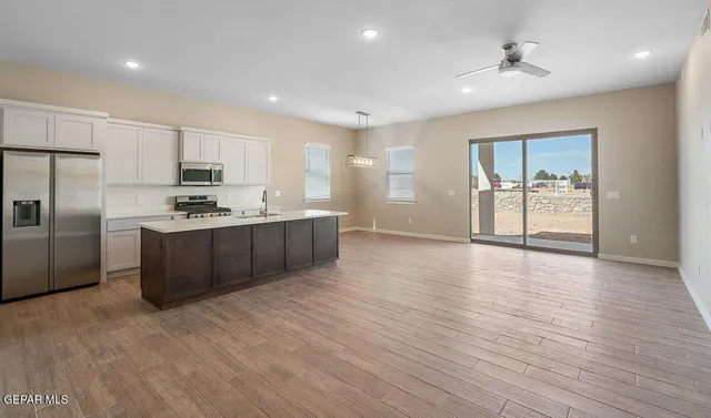 a kitchen with stainless steel appliances a refrigerator sink and cabinets