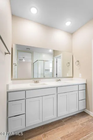a bathroom with double sink and a large mirror