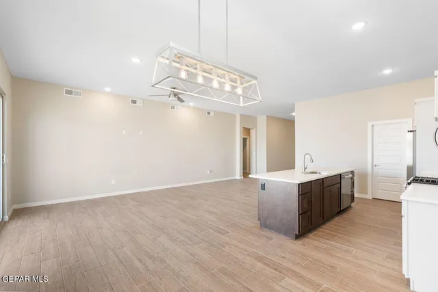 a view of a kitchen with a sink and cabinets