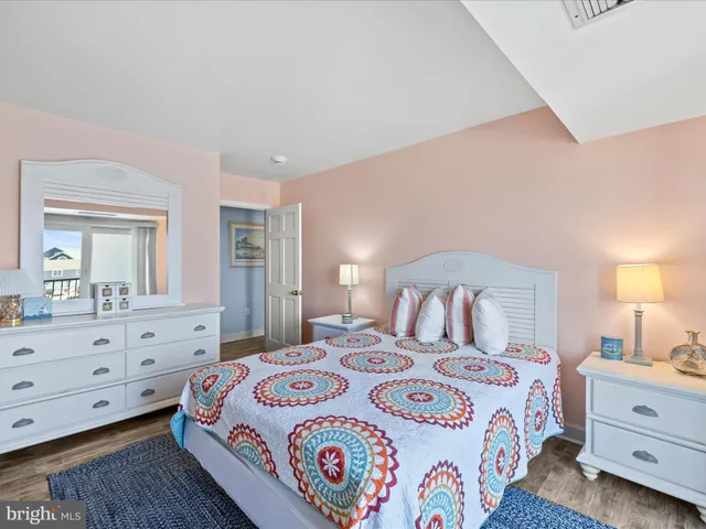 a bedroom with a bed and a dresser in it