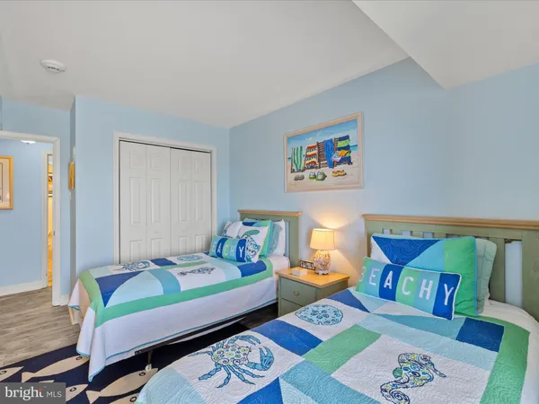 a bedroom with a bed and a wooden floor