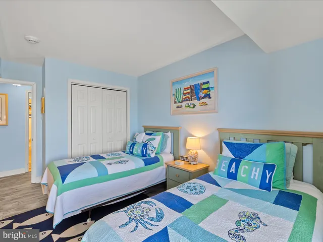 a bedroom with a bed and a wooden floor