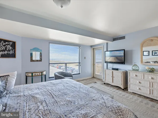 a bedroom with a bed and flat screen tv
