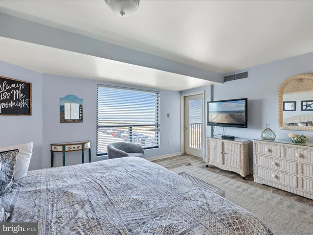 a bedroom with a bed and flat screen tv