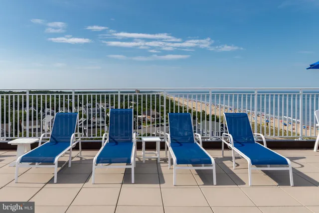 a terrace with outdoor seating and city view
