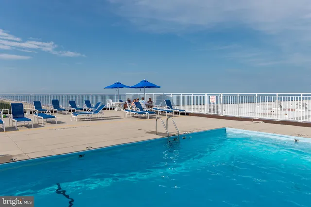 a swimming pool with outdoor seating and yard