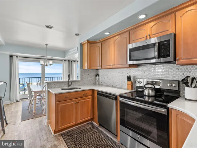 a kitchen with stainless steel appliances a stove sink microwave and cabinets