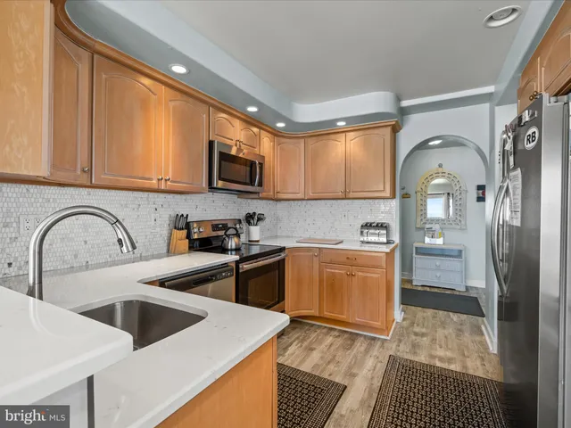 a kitchen with a sink cabinets and stainless steel appliances