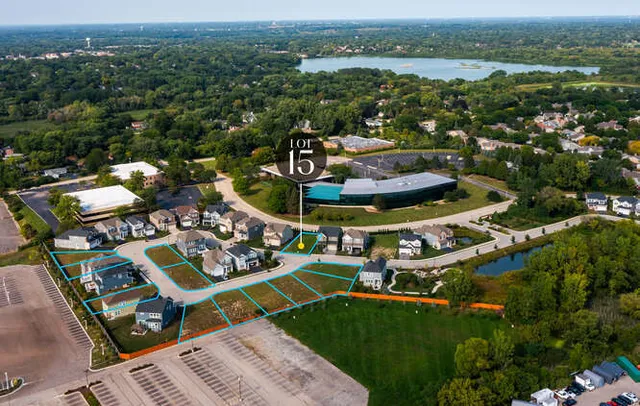 an aerial view of a house with a garden and lake view